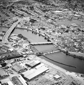 General oblique aerial view of the town, centred on the road bridges, school and sawmill, taken from the NE.