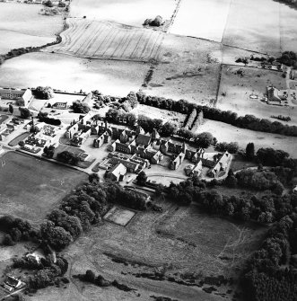 Oblique aerial view centred on the hospital and churches, taken from the WSW.