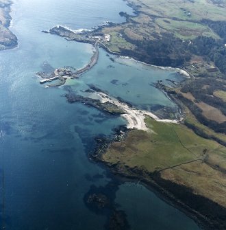 Oblique aerial view centred on the construction of the new pier, with harbour, pier and fish traps adjacent, taken from the N.