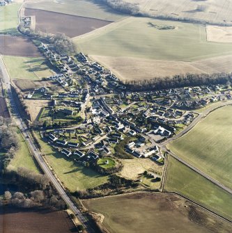 General oblique aerial view centred on the town, church, dovecot and remains of the motte taken from the NW.