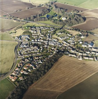 General oblique aerial view centred on the town, church, dovecot and remains of the motte taken from the S.
