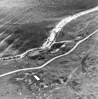 Aerial view of Nigg Second World War coast battery from the N. Two partly demolished gun-emplacements are visible.  The gun-emplacements have been built into the remains of Dunskeath Castle.