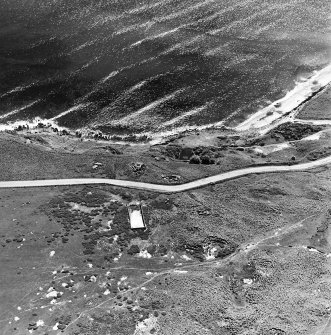 Aerial view of Nigg Second World War coast battery from the N. Two partly demolished gun-emplacements are visible.  One of the gun-emplacements has been built into the remains of Dunskeath Castle.