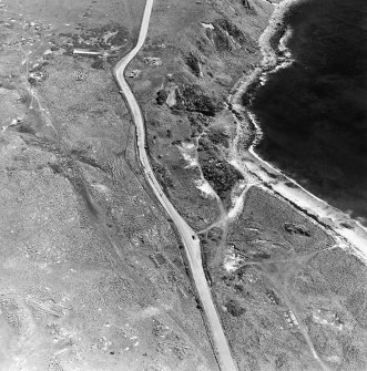 Aerial view of Nigg Second World War coast battery and accommodation camp from the W.  The two partly demolished gun-emplacements are visible. One of the gun-emplacements has been built into the remains of Dunskeath Castle.