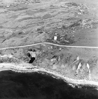 Aerial view of Nigg Second World War coast battery and accommodation camp from the S.  The two partly demolished gun-emplacements are visible. One of the gun-emplacements has been built into the remains of Dunskeath Castle.