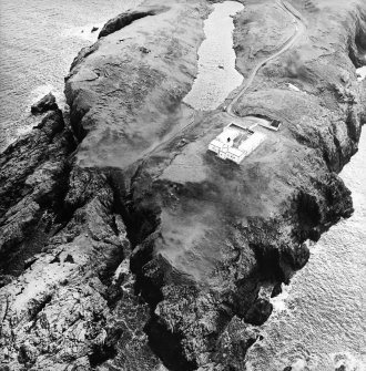 Oblique aerial view centred on the lighthouse, taken from the NW.