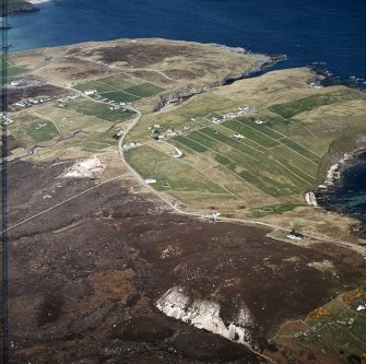 Oblique aerial view centred on the crofting townships with the remains of the radar station adjacent, taken from the SE.
