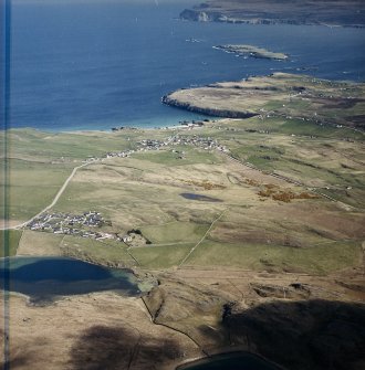 General oblique aerial view looking across the village towards the crofting township and radar station, taken from the W.