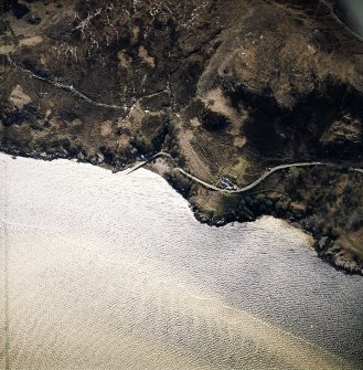 Oblique aerial view centred on the house, enclosure and jetty, taken from the NNE..