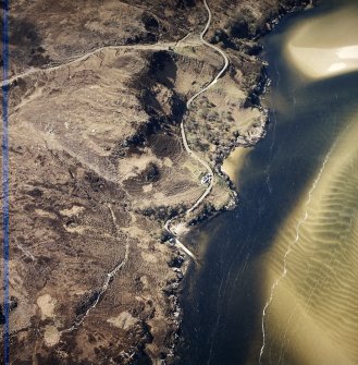 Oblique aerial view centred on the house, enclosure and jetty, taken from the ESE.
