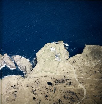 Oblique aerial view centred on the lighthouse, keepers' cottages, cottages and support buildings, taken from the SW.
