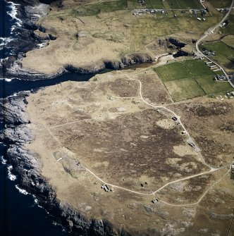 Oblique aerial view centred on the remains of the radar station with caves and crofting townships adjacent, taken from the NW.