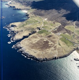 General oblique aerial view centred on the crofting townships, cave and the remains of the radar station, taken from the NW.