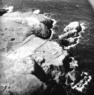 Oblique aerial view centred on the lighthouse, keepers' cottages, cottages and support buildings with the radar station adjacent, taken from the E.
