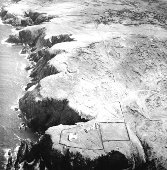 Oblique aerial view centred on the lighthouse, keepers' cottages, cottages and support buildings with the radar station adjacent, taken from the NW.