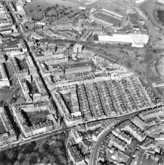 Oblique aerial view of Easter Road, showing Eastern Cemetery and Albion Road, Easter Road Stadium