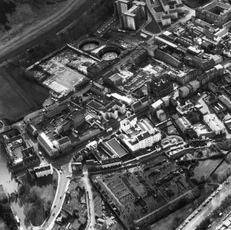 Aerial view showing Canongate across centre of photograph, Calton Burial Ground at bottom, Abbey Strand to left, Meadow Flat Gas Holder at top and Cowgate heading to right