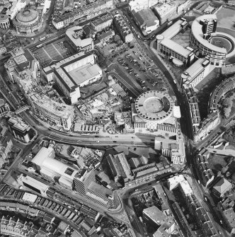 Oblique aerial view of Edinburgh centred on the construction of Exchange Crescent and the Sheraton Grand Hotel Spa, taken from the NW.
