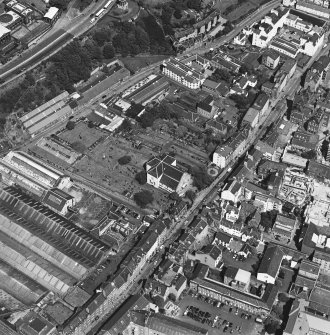 Oblique aerial view centred on the church and graveyard, taken from the WSW.