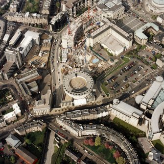 Oblique aerial view of Edinburgh centred on the Edinburgh International Conference Centre with the construction of Exchange Crescent adjacent, taken from the SW.