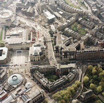 Oblique aerial view of Edinburgh centred on the Standard Life office building, Lothian Road, with the construction of Exchange Crescent adjacent, taken from the E.