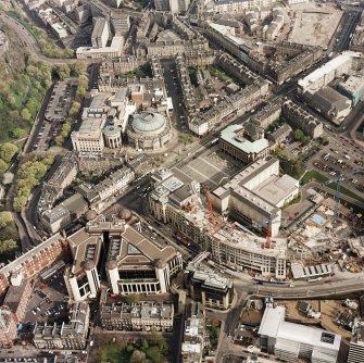 Oblique aerial view of Edinburgh centred on the construction of Exchange Crescent with the construction of the Sheraton Grand Spa adjacent, taken from the NW.