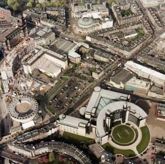 Oblique aerial view of Edinburgh centred on the Scottish Widows building with the construction of Exchange Crescent adjacent, taken from the SW.