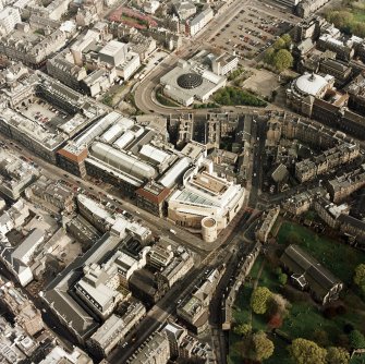 Oblique aerial view of Edinburgh centred on the Museum of Scotland, taken from the NW.