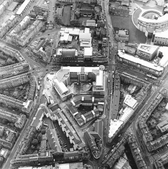 Oblique aerial view centred on the bank, shop and offices, taken from the ENE.