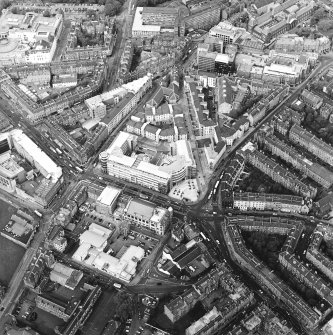 Oblique aerial view centred on the bank, shop and offices, taken from the SSW.