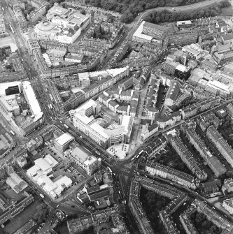 Oblique aerial view centred on the bank, shop and offices, taken from the SSW.