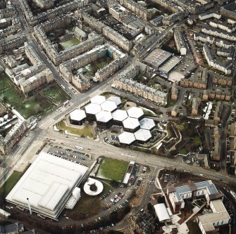 Oblique aerial view centred on the offices with the swimming pool, school, burial ground and church adjacent, taken from the ESE.