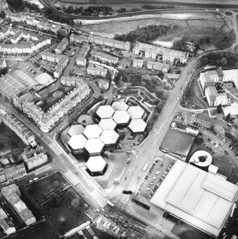 Oblique aerial view centred on the offices with the swimming pool, school, burial ground and church adjacent, taken from the SSW.