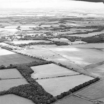 Oblique aerial view of Kirknewton Airfield centred on the airfield, taken from the SSW.
