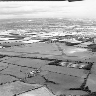 Oblique aerial view of Kirknewton Airfield centred on the airfield, taken from the SE.