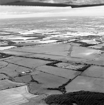 Oblique aerial view of Kirknewton Airfield centred on the airfield, taken from the ESE.