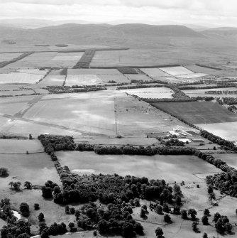 Oblique aerial view of Kirknewton Airfield centred on the airfield, taken from the NNW.