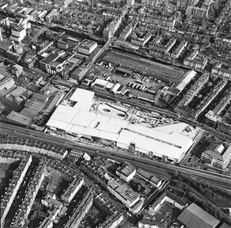 Oblique aerial view of Edinburgh centred on the construction of the Fountain Park Leisure Centre, taken from the WNW.