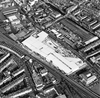 Oblique aerial view of Edinburgh centred on the construction of the Fountain Park Leisure Centre, taken from the W.