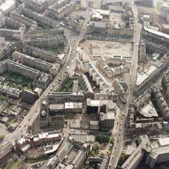 Oblique aerial view of Edinburgh centred on the Inland Revenue offices, Lauriston Place, taken from the NE.