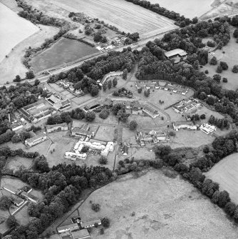 Oblique aerial view centred on the hospital before development, taken from the SSW.