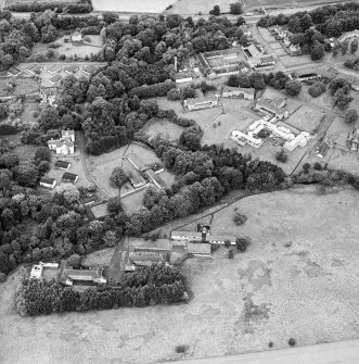 Oblique aerial view centred on the hospital before development and house, taken from the SSE.