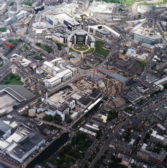 Oblique aerial view centred on the brewery with the canal, canal basin and canal bridge adjacent, taken from the SSW.