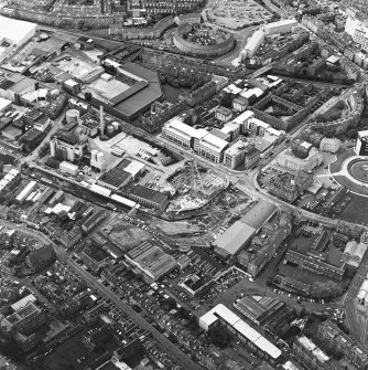 Oblique aerial view centred on the brewery with the leisure centre and cinema, canal, canal basin and canal bridge adjacent, taken from the SE.