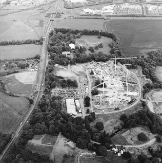 Oblique aerial view centred on the Royal Bank of Scotland headquarters under construction with the hospital and house and the excavation adjacent, taken from the WSW.