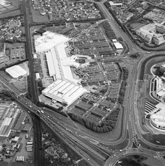 Oblique aerial view centred on the shopping centre with the industrial estate adjacent, taken from the SE.