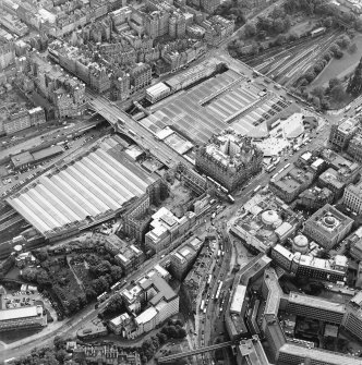 Oblique aerial view centred on the redevelopment of the former post office, with the register house under repair and the railway station and hotel adjacent, taken from the NNE.