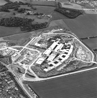 Oblique aerial view centred on the Royal Infirmary of Edinburgh at Little France under construction, taken from the S.
