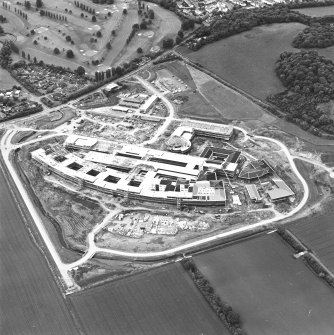 Oblique aerial view centred on the Royal Infirmary of Edinburgh at Little France under construction, taken from the E.