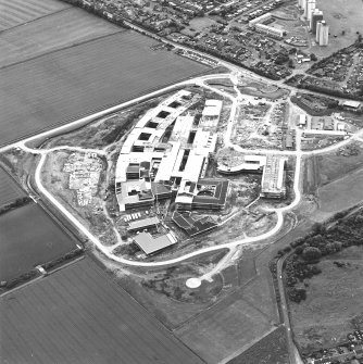 Oblique aerial view centred on the Royal Infirmary of Edinburgh at Little France under construction, taken from the NE.